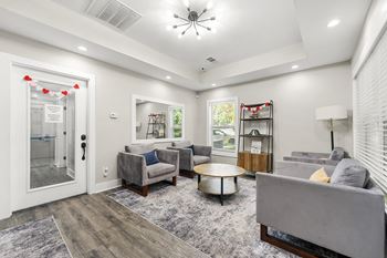 A living room with a grey couch and a coffee table.
