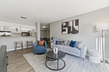 Atlanta apartment for rent - A modern living room with a white couch and a coffee table.
