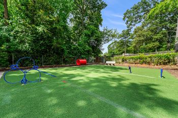 A tennis court with nets on it and trees