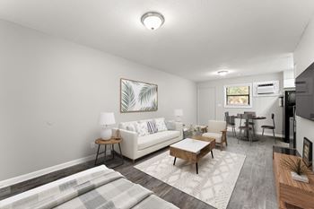 A living room with a white couch and a wooden coffee table