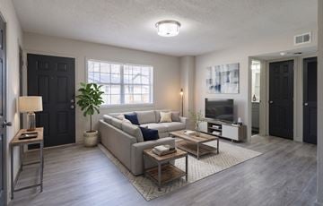 Atlanta apartment for rent - A modern living room with a grey sofa set and a wooden coffee table.