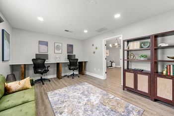 A living room with a couch and a desk