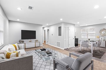 Smyrna apartment for rent - A modern living room with a grey sofa and a glass coffee table.