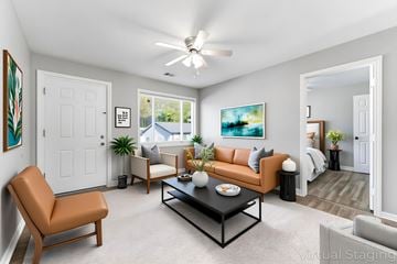 Atlanta apartment for rent - A living room with a brown leather chair, a black coffee table, and a painting on the wall.