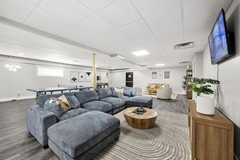 Clubhouse with large blue couch and tv 