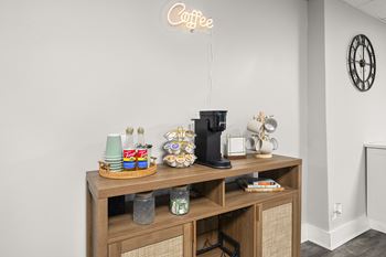 A coffee bar in the clubhouse with a coffee sign on the wall