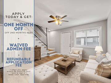 Sandy Springs apartment for rent - A room with a staircase and a couch with a sign offering a free month of rent.