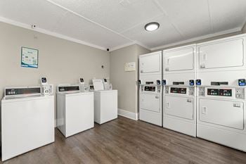 Our laundry room is equipped with washers and dryers and has a row of