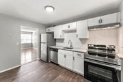 Atlanta apartment for rent - a kitchen with stainless steel appliances and white cabinets at Gardens at Washington Park, Atlanta, Georgia