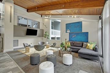 Atlanta apartment for rent - A living room with a grey couch and a wooden ceiling.