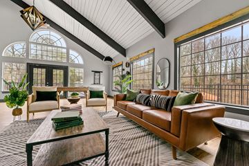 Norcross apartment for rent - A living room with a brown leather couch and a wooden coffee table.