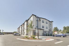 Longmont apartment for rent - an empty parking lot in front of an apartment building