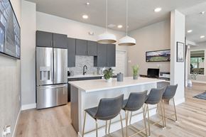 Longmont apartment for rent - a kitchen with a large island and a stainless steel refrigerator