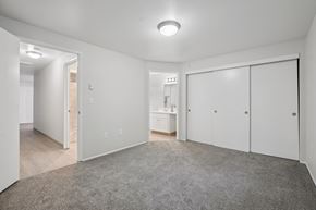Vancouver apartment for rent - A spacious room with a grey carpet and white walls.