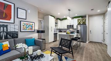 Tampa apartment for rent - a living room and kitchen with a couch and a table