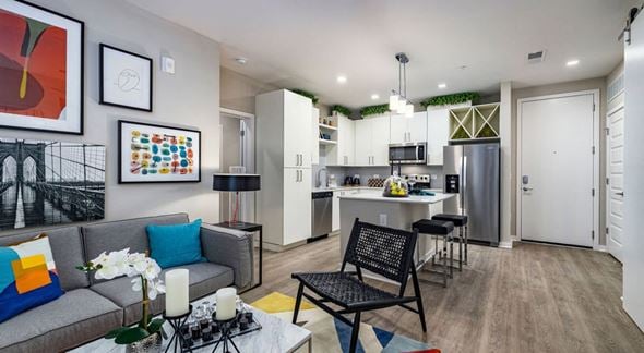 Tampa apartment for rent - a living room and kitchen with a couch and a table