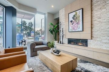 Denver apartment for rent - A living room with a fireplace and a painting on the wall.
