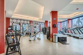 Denver apartment for rent - A gym with a variety of equipment including treadmills, weights, and a rowing machine.