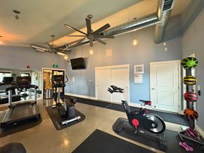 Vancouver apartment for rent - A gym with treadmills, exercise bikes, and a ceiling fan.