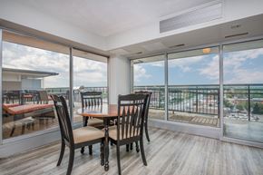 Denver apartment for rent - Resident lounge area with table and chairs surrounded by large windows
