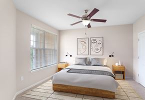 Hendersonville apartment for rent - a bedroom with a large bed and a ceiling fan
