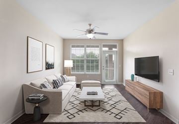 Hendersonville apartment for rent - an open living room with a white couch and a tv