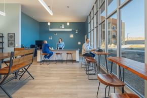 Rio Rancho apartment for rent - A man in a blue shirt is sitting at a table in the leasing office