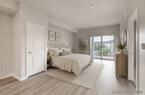 Loveland apartment for rent - A bedroom with a large bed and a sliding glass door.