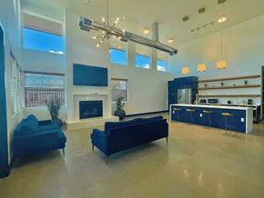Aurora apartment for rent - A modern clubhouse with a fireplace and a bar area.