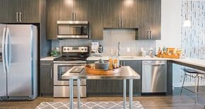 Nashville apartment for rent - a kitchen with stainless steel appliances and a table