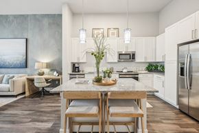 Sanford apartment for rent - A modern kitchen with a dining table and chairs in the foreground.