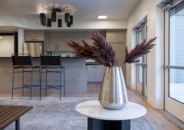 Steamboat Springs apartment for rent - A silver vase with purple plants sits on a white table in a modern kitchen.