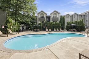 Vancouver apartment for rent - A swimming pool surrounded by a concrete patio and lounge chairs.