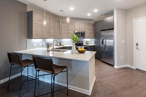 Decatur apartment for rent - A modern kitchen with a large island and chairs.
