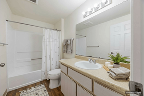 Durham apartment for rent - A bathroom with a white toilet, sink, and shower.