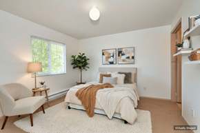 Vancouver apartment for rent - A bedroom with a bed, chair, and lamp.