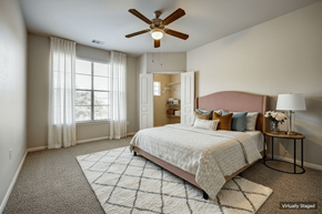 San Antonio townhouse for rent - A bedroom with a large bed and a ceiling fan.
