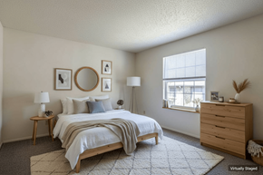 Laurel apartment for rent - A bedroom with a bed, nightstand, and lamp.