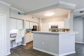 Colorado Springs apartment for rent - a kitchen with white cabinets and a large island with a counter top