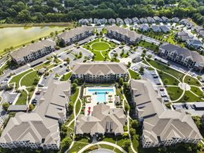 Overland Park apartment for rent - A bird's eye view of a residential complex with a swimming pool in the center.