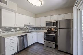 Colorado Springs apartment for rent - a kitchen with stainless steel appliances and white cabinets
