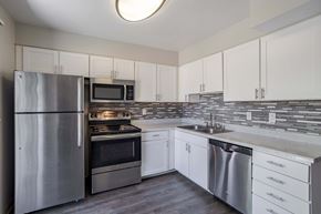 Colorado Springs apartment for rent - a kitchen with stainless steel appliances and white cabinets