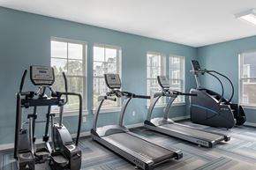 Charlotte apartment for rent - A gym with treadmills, elliptical machines, and a stationary bike.