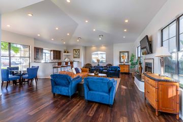 Tucson apartment for rent - a living room with blue chairs and a fireplace