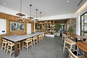 Kennesaw apartment for rent - A modern dining room with a long table and chairs.