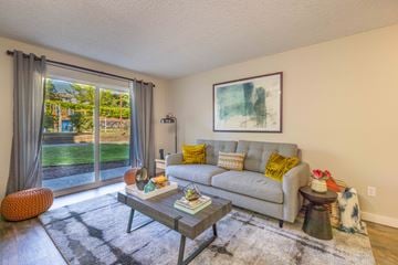 Everett apartment for rent - A living room with a grey couch, a coffee table, and a painting on the wall.