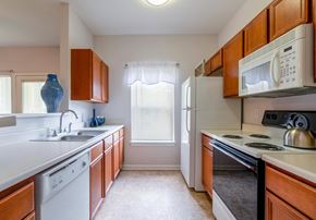Independence apartment for rent - a kitchen with white appliances and wooden cabinets