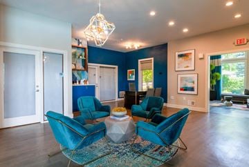 Independence apartment for rent - a living room with blue chairs and a table
