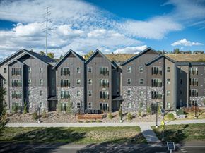 Steamboat Springs apartment for rent - A row of modern houses with grey exteriors and stone accents.