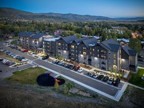 Steamboat Springs apartment for rent - A large building complex with a parking lot in front of it.